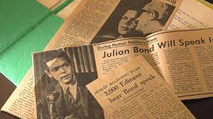 Photo of old, yellowed newspaper clippings featuring stories of Julian Bond's visit to Edina, Minnesota